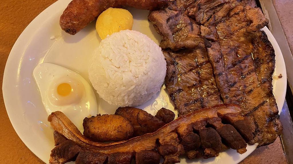 Plato Montañero · Beef, pork, chicken or ground beef (6 oz) with rice, beans, chorizo, fried pork rinds, sweet plantain, corn arepa and egg.