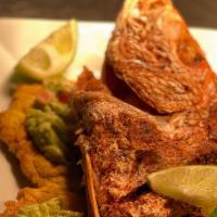 Red Snapper · served with fried tostones with guacamole and criollo sauce ,rice and salad