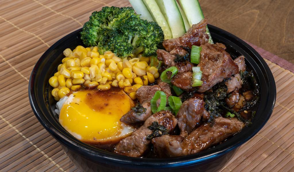 Beef Steak Bowl · Rice and protein in a bowl with vegetable corn fried egg spring onion cucumber and seaweed.