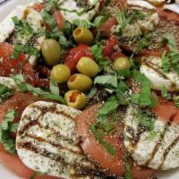 Mozzarella Caprese · Gluten free. Fresh mozzarella sliced tomatoes fresh basil topped with balsamic glaze extra v...