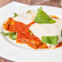 Lasagna · Layered pasta with meat sauce ricotta mozzarella ham parmigiano.