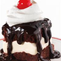 Hot Fudge Cake · Vanilla ice cream sandwiched between two fudge cakes, smothered with hot fudge and topped wi...