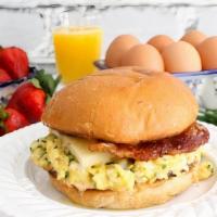 Egg, Bacon & Cheese Breakfast Sandwich · Two scrambled eggs with cheddar cheese and one slice of bacon on a buttered brioche bun.