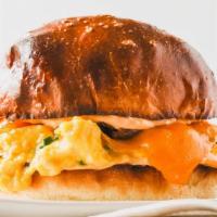 Egg & Cheese Breakfast Sandwich · Two scrambled eggs with cheddar cheese on a buttered brioche bun.