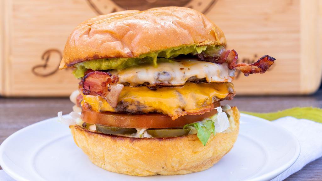 H-Town Sizz · Freshly ground one-third pound beef patty, Wisconsin Cheddar, pepper Jack, crispy bacon, fresh guacamole, diced onion, pickled jalapeño, shredded lettuce, tomato, and buttermilk ranch.