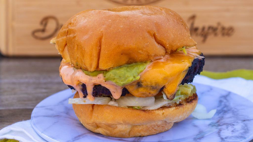 Blackbean Sizz · Black bean burger topped with American cheese, shredded lettuce, tomato, diced onion, pickles, fresh guacamole, and spicy ranch.