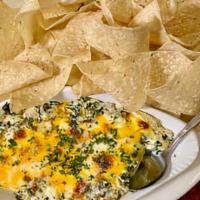 Spinach Artichoke Dip · Creamy spinach artichoke dip topped with Monterey Jack & Cheddar cheese, and served with fre...