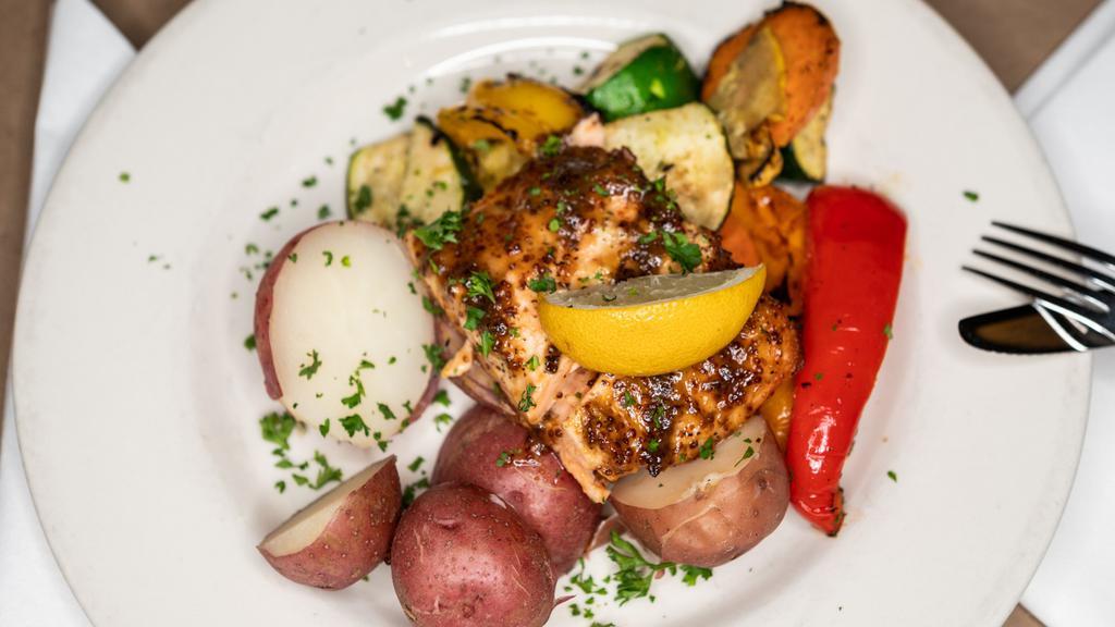 Salmon O'Connor · Fresh Atlantic salmon brushed with a fresh maple, mustard and ale glaze, char grilled to perfection. Served with fire roasted vegetable and red skin potatoes.