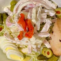 Maurice Salad · Strips of smoked turkey, ham and Swiss cheese tossed in Maurice dressing set on top of shred...