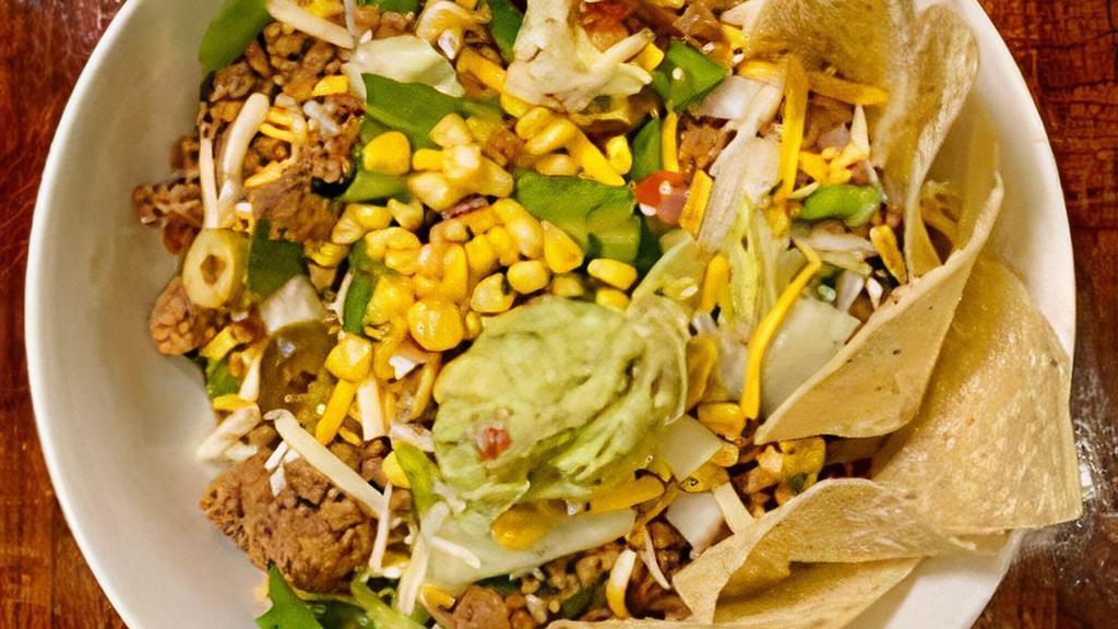 Taco Salad · Chopped greens, seasoned ground beef, green olives, pico de gallo, Monterey Jack & Cheddar cheeses, jalapeño, onion, green pepper, tossed in Cholula ranch. Served with fresh corn salsa.