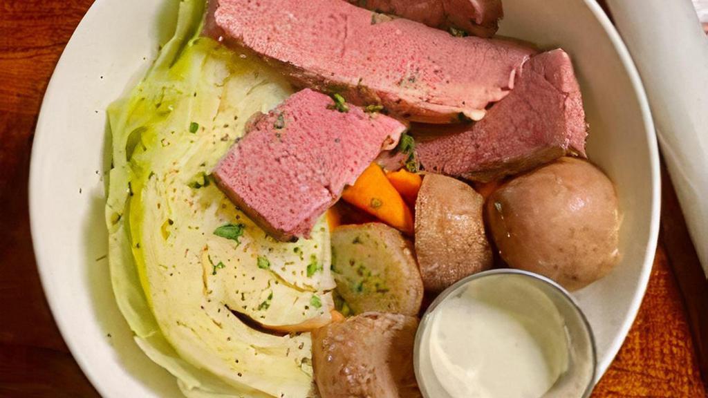 Corned Beef & Cabbage · Corned beef served with a side of horseradish sauce, boiled red potatoes, carrots and buttery cabbage.