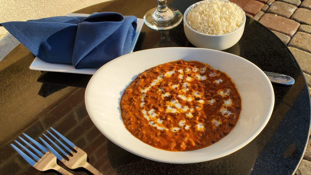 Dal Makhani  · Black Lentils cooked in slow fire overnight, finished with butter and tomato gravy