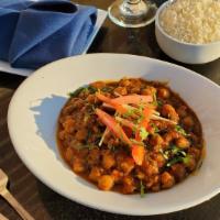 Chana Masala  · Spiced chick peas curry cooked in tomato onion sauce with chana masala