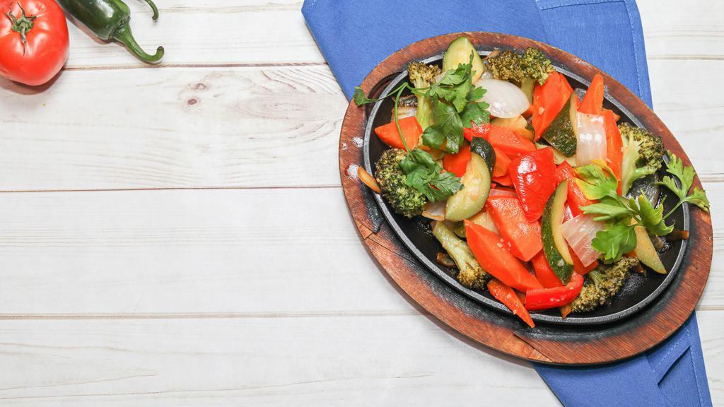 Vegetarian Fajita · Fajita with zucchini, onions, green peppers, red peppers, broccoli, mushrooms, carrots and celery, served with rice, beans, sour cream, pico de gallo and guacamole.