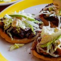 Picaditas Sopes · A traditional antojito snack. Three handmade tortillas topped with your choice of carnitas,