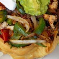 Taco Salad Cancun · Flour tortilla bowl, stuffed with greens, roasted corn, guacamole, mango, sour cream, pico d...