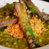 Costilla De Cerdo Verde · Stewed pork ribs with tomatillo salsa, nopales, and vegetables. Served rice, salad and torti...