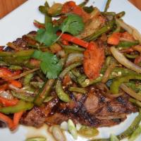 Steak Mexicano · Grilled rib eye steak with onions, jalapeños and tomatoes. Served with rice, beans and torti...