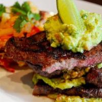 Steak Con Guacamole · Grilled charbroiled New York steak, served with Mexican mash potatoes, guacamole and side of...