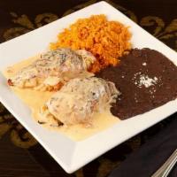 Pollo Cancun · Two chicken breasts stuffed with ham, vegetables and cheese, topped with our chorizo salsa. ...
