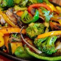Fajitas Vegetarian · Grilled green peppers, onions, zucchini, yellow squash, and mushrooms. Served with salad, gu...
