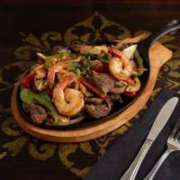 Fajitas Texanas · Grilled bell peppers, onions, tomatoes, your choice of meat seasoned with our special ingred...