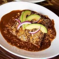Enchiladas De Mole · Three soft corn tortillas rolled and stuffed with queso fresco, chicken and topped with Oaxa...