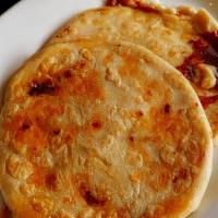 Pupusas (2Pc) · Traditional Salvadorian dish made with corn dough and stuffed with the options of (Queso, Fr...