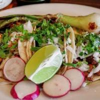 Mexican Street Tacos · Authentic Mexican Tacos made with corn tortillas, choice of protein, onions and cilantro.