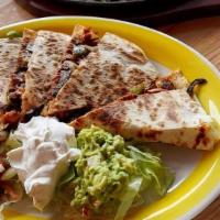Quesadilla Clasica · 12” flour tortilla stuffed with cheese and your choice of protein. Served with salad, guacam...