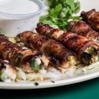 Handmade Stuffed Jalapeños · Stuffed with shrimp, crab and Pepper Jack cheese wrapped in bacon and served with ranch dres...