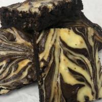Cheesecake Brownie · Fudgy, rich brownie with a ribbon of New York cheesecake swirled throughout.