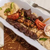 Super Deluxe Mixed Grill (For Two) · Three skewers, grilled veggie, hummus, baba ghannouj, and fattouche.