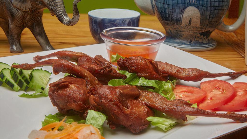 C-9. Fried Quail (Com Chim Cut) · Fried quail served on steamed rice and fresh vegetables.