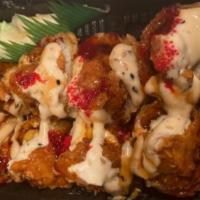 Volcano Roll · Inside: spicy crab, cream cheese and avocado, outside: rolled and tempura fried, spicy tuna,...