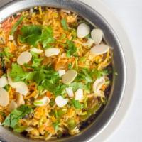 Vegetable Biryani · Basmati rice, richly flavored with saffron, nuts, and raisins.