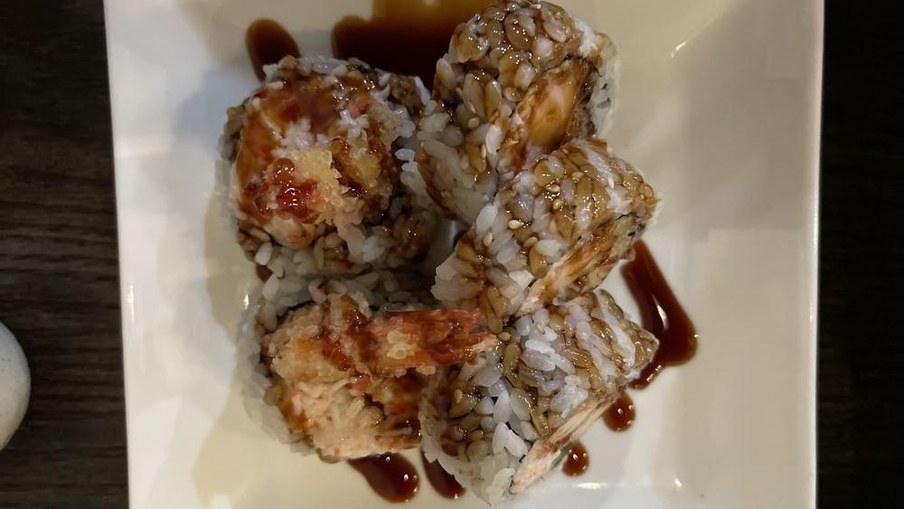Shaggy Dog Roll · Shrimp tempura inside, crab stick, spicy sauce on top.