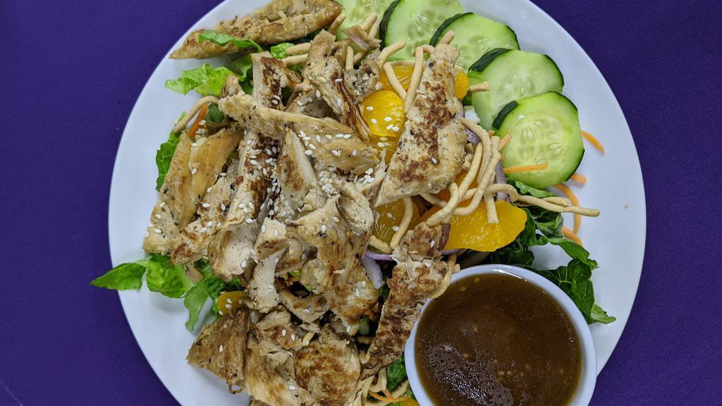Asian Grilled Chicken Salad · Marinated ginger sesame grilled chicken breast on a fresh crispy bed of romaine lettuce topped with cucumbers, red onions, mandarin oranges, carrots, and crispy noodles. Served with House ginger dressing.