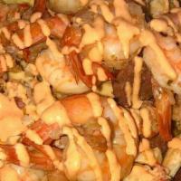 Seafood Nachos · The Seafood Nachos are served with sausage, shrimp, crawfish tails, and chicken. Topped with...