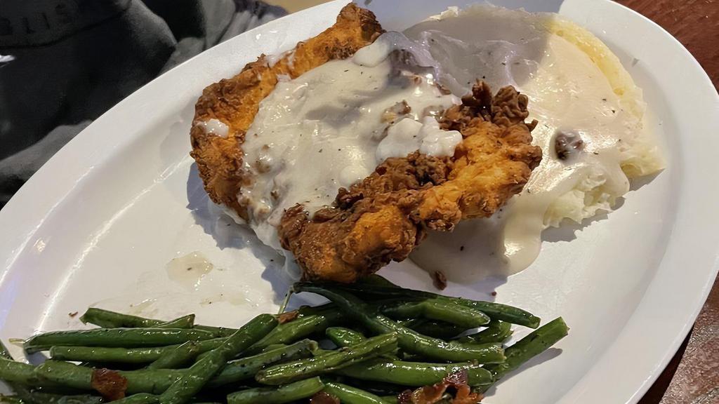 Chicken Fried Chicken · Huge all-natural chicken breast hand breaded and fried golden perfection and smothered in our country gravy. served with garlic whipped mashed potatoes and sauteed green beans with bacon and onions.