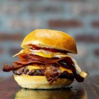 #16 B.A.D. Breakfast Burger · Angus Beef Burger seared with Maple Syrup, topped with a Fried Egg, Pork Roll, Bacon, Americ...