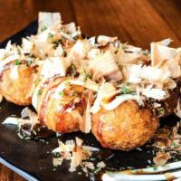 Takoyaki · Deep fried ball-shaped Japanese appetizer filled with diced octopus. Topped with bonito flak...