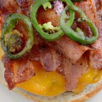 The Back To Best Burger · Burger topped with bacon, cheddar, jalapeños, caramelized onion mayo. Served on a brioche bu...