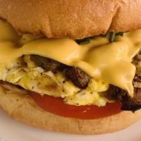Egg, Sausage & Cheese Breakfast Sandwich · Two scrambled eggs with cheddar cheese and chicken sausage on a buttered brioche bun.