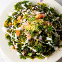 Palak Chat · Crispy baby spinach and tamarind sauce with sweet yogurt dressing.