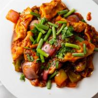 Chilly Momo (Dumpling) · Chicken and vegetables dumpling deep fried and sautéed with tomatoes, chilly, red onion, bel...