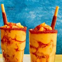 Mangonada · sweet mango base with 
layers of spicy Chamoy 
and Tajin seasoning
& Mango Popping on top