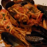 Spaghetti Alla Pescatora · Homemade spaghetti served with manila clams, mussels, shrimps and squids.