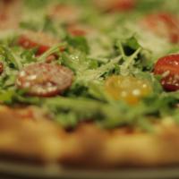 Pizza Crudo E Rucola · Tomato sauce, mozzarella, prosciutto crudo, Arugula, fresh tomatoes and parmesan cheese.