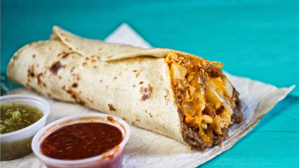 El Campeon · Signature chorizo & egg, fried potatoes, refried beans, and shredded cheese wrapped in a freshly made flour tortilla